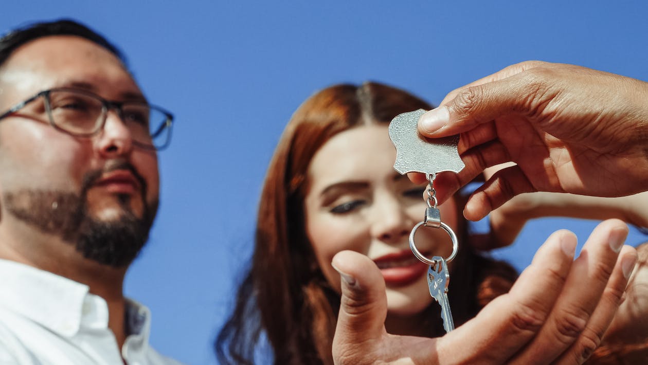 Free Person Giving a House Key Stock Photo